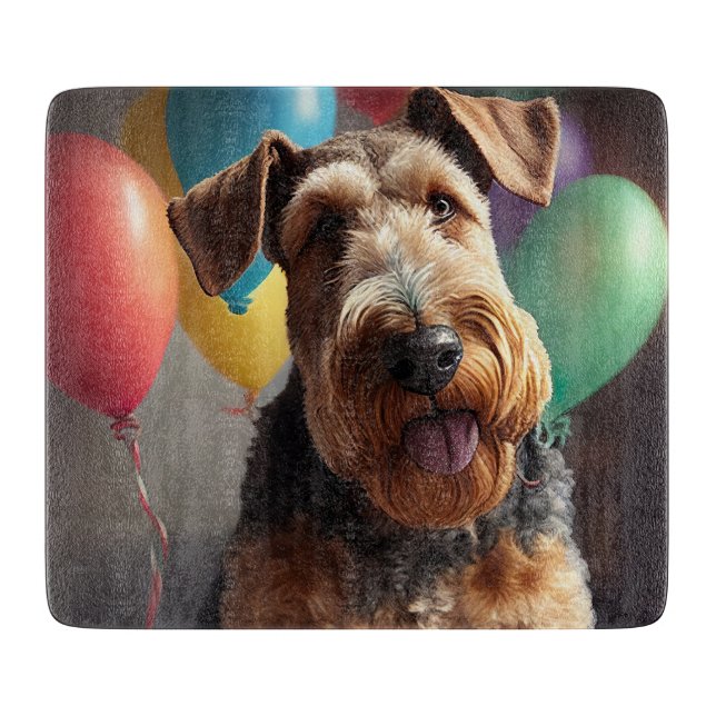 Airedale dog with cake and balloons cutting board (Front)