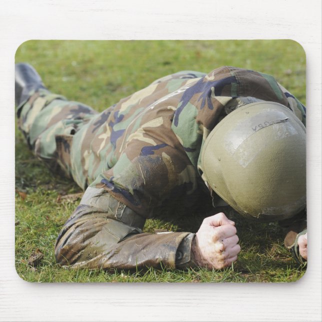Airman crawls through a wet field mouse mat (Front)