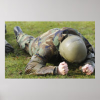 Airman crawls through a wet field