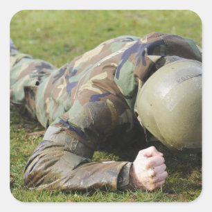 Airman crawls through a wet field square sticker