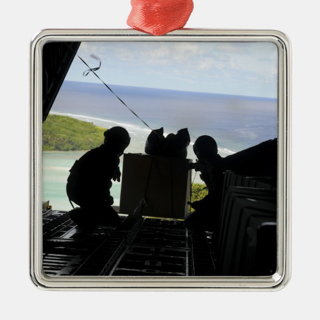 Airmen push out a pallet of donated goods metal tree decoration (Front)