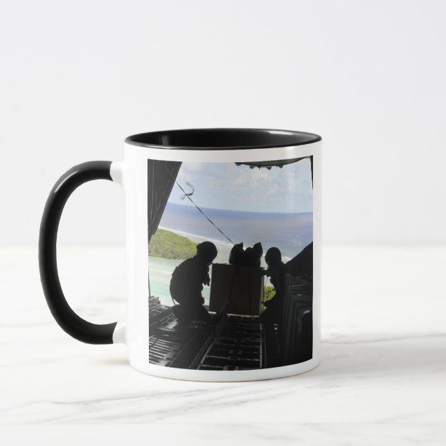 Airmen push out a pallet of donated goods mug (Left)