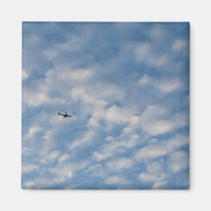 Airplane Crossing a Cloud-Filled Blue Sky Magnet
