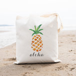 Aloha Tropical Watercolor Pineapple Tote Bag<br><div class="desc">Cute tote bag design features a pineapple illustration, the traditional symbol of hospitality, in sheer, pretty watercolors. Dark gray calligraphy script lettering defaults to "aloha, " but you can easily replace the text and personalize with a name or message. Makes a great welcome bag or favor for Hawaii weddings or...</div>