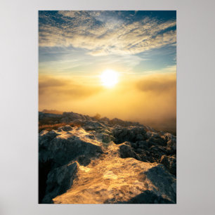 Amazing sunset above clouds and sun lit rocks poster