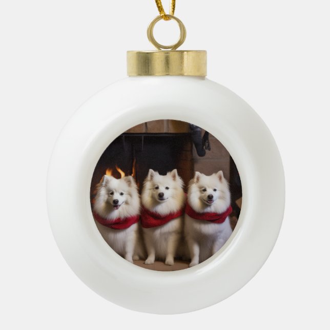 American Eskimo by the Fireplace Christmas Ceramic Ball Christmas Ornament (Front)