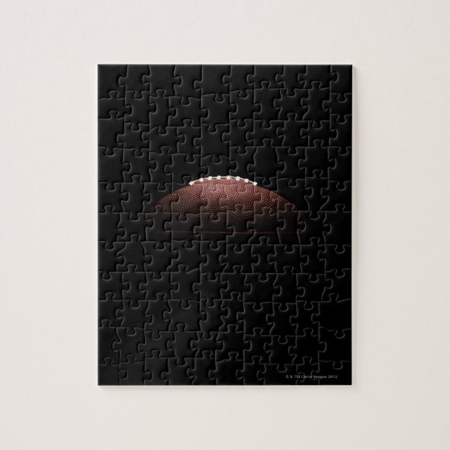 American football ball on black background jigsaw puzzle (Vertical)