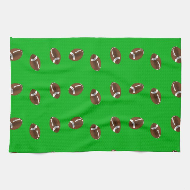 American football balls on green tea towel (Horizontal)