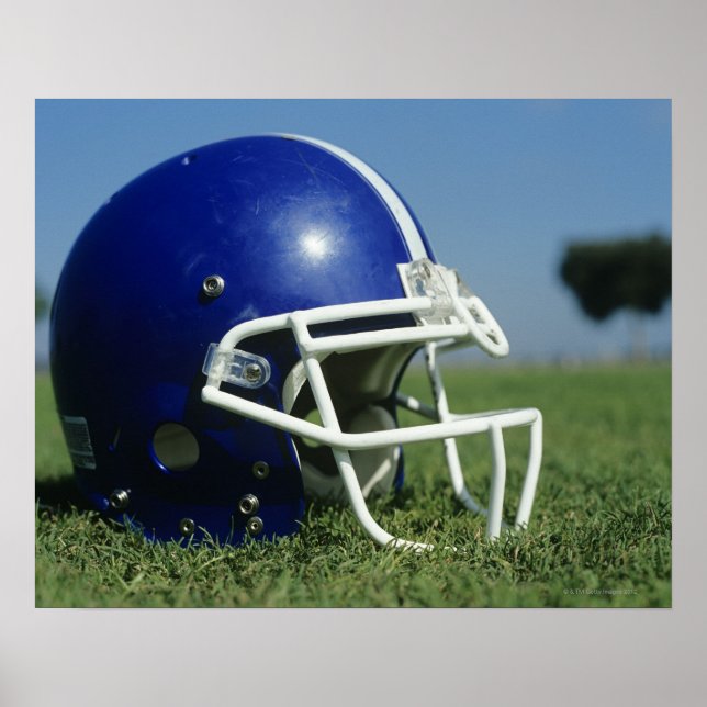 American football helmet in grass,close-up poster (Front)