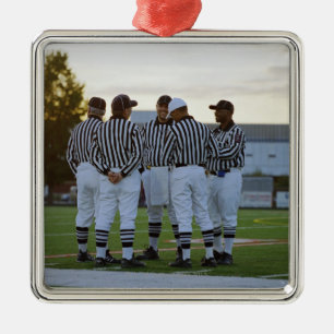 American football referees talking in field metal tree decoration
