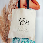 Ampersand Monogram Wedding Welcome Tote Bag<br><div class="desc">Simple and chic wedding welcome tote bags feature your initials worked into a monogram design,  joined by a decorative script ampersand. Personalise with your wedding date and location beneath in timeless serif lettering. Perfect as favours or hotel gift bags.</div>