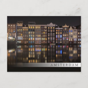 Amsterdam houses with colourful lights in the nigh postcard