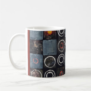 An abstract painting; a grid of stamped circles on coffee mug