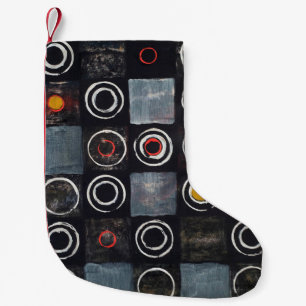 An abstract painting; a grid of stamped circles on small christmas stocking
