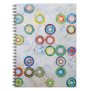 An abstract painting; multicolored circles on a gr notebook