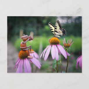 An acorn elf is taking a picture of a butterfly postcard