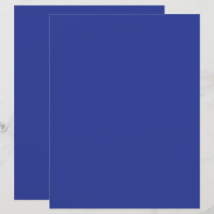 an aeroplane flying in the sky with a blue backgro