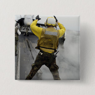 An aircraft director signals a F/A-18C Hornet 15 Cm Square Badge