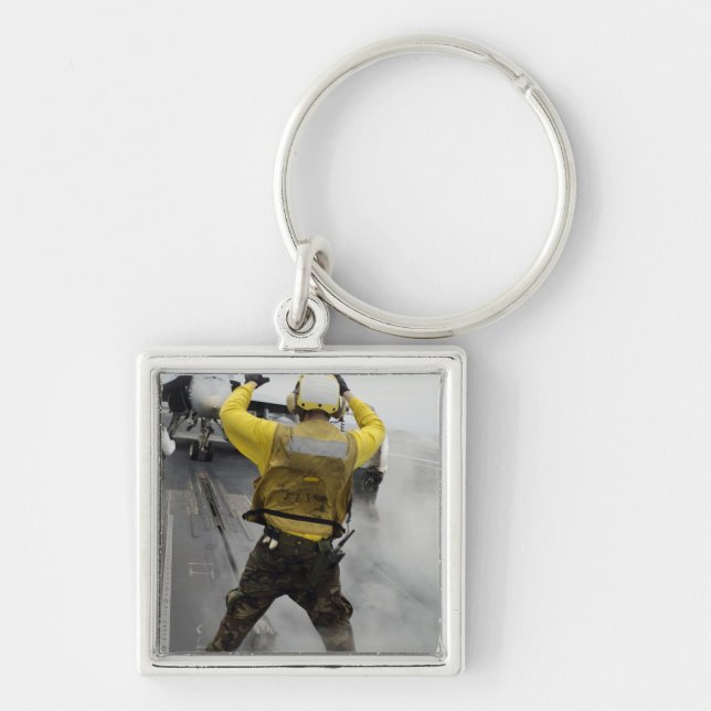 An aircraft director signals a F/A-18C Hornet Key Ring (Front)