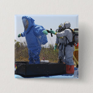 An airman stands in a tub 15 cm square badge