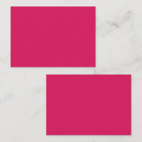 An array of red and pink flowers with lush green l