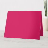 An array of red and pink flowers with lush green l