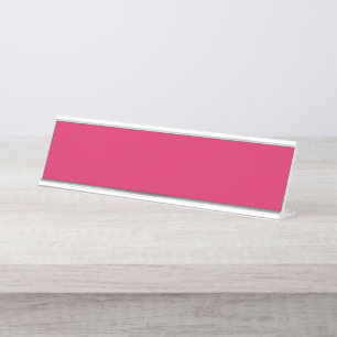 An array of red and pink flowers with lush green l desk name plate