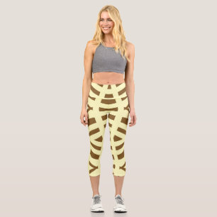 An elegant yellow brown all over fabric pattern capri leggings