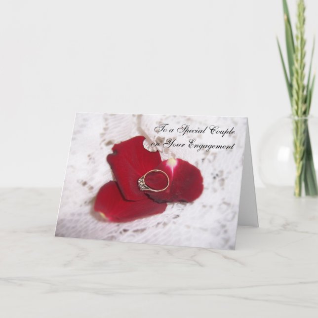 An Engagement Card Diamond Ring And Rose Petals (Front)