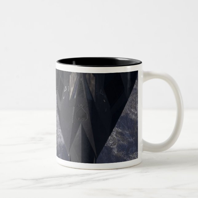 An F-117A Nighthawk flies high over the mountai Two-Tone Coffee Mug (Right)