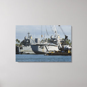 An F-15 Eagle gets a lift from a barge crane Canvas Print