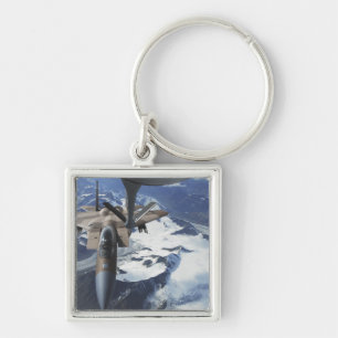 An F-15C Eagle aircraft sits behind a KC-135R Key Ring