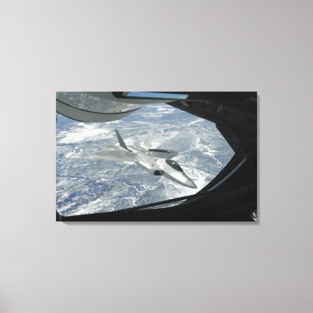 An F-22 Raptor banks away from a KC-135 Canvas Print (Front)