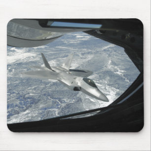 An F-22 Raptor banks away from a KC-135 Mouse Mat