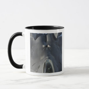 An F-22 Raptor moves into position to receive f Mug