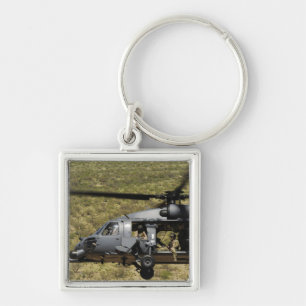 An HH-60 Pave Hawk flies over the desert Key Ring