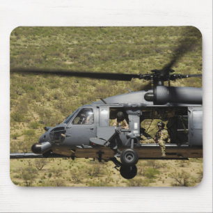 An HH-60 Pave Hawk flies over the desert Mouse Mat