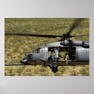 An HH-60 Pave Hawk flies over the desert Poster