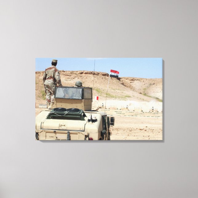 An instructor watches as an Iraqi army soldier Canvas Print (Front)