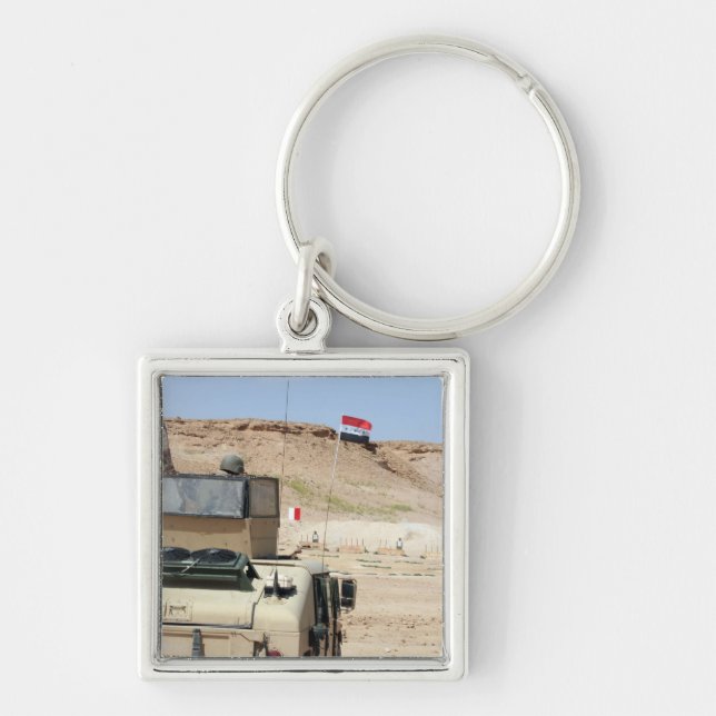 An instructor watches as an Iraqi army soldier Key Ring (Front)