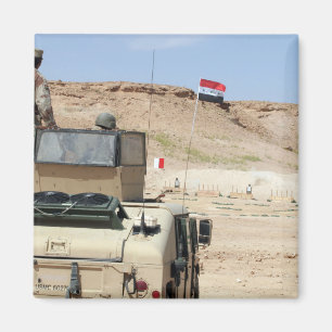An instructor watches as an Iraqi army soldier Magnet