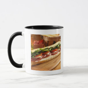 An Italian sub sandwich with 2 Mug