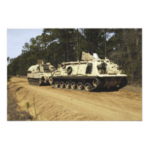 An M-88 recovery vehicle begins to tow an M992 Photo Print