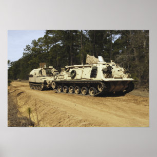 An M-88 recovery vehicle begins to tow an M992 Poster