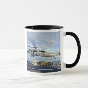 An MH-60S Seahawk prepares to deliver ammunitio Mug