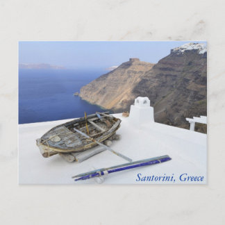 An old boat on the roof of a house in Santorini Postcard