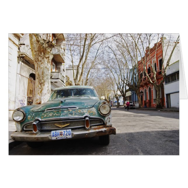 An old car rusty and flaky colour parked in the (Front Horizontal)