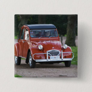 An old red Citroen 2CV car with a smiling woman 15 Cm Square Badge