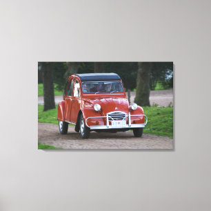 An old red Citroen 2CV car with a smiling woman Canvas Print