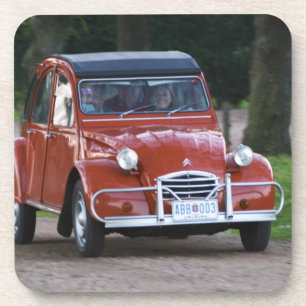 An old red Citroen 2CV car with a smiling woman Coaster